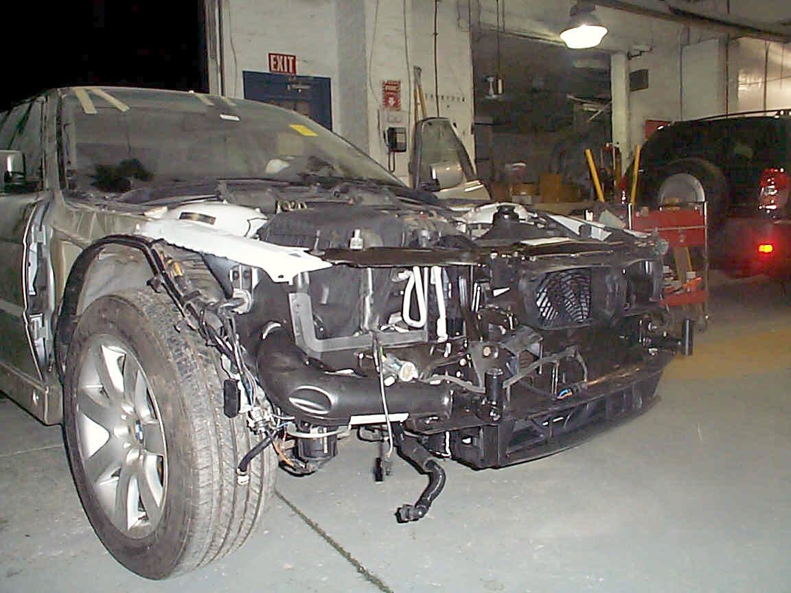 A BMW in our shop with its front end taken apart for repair