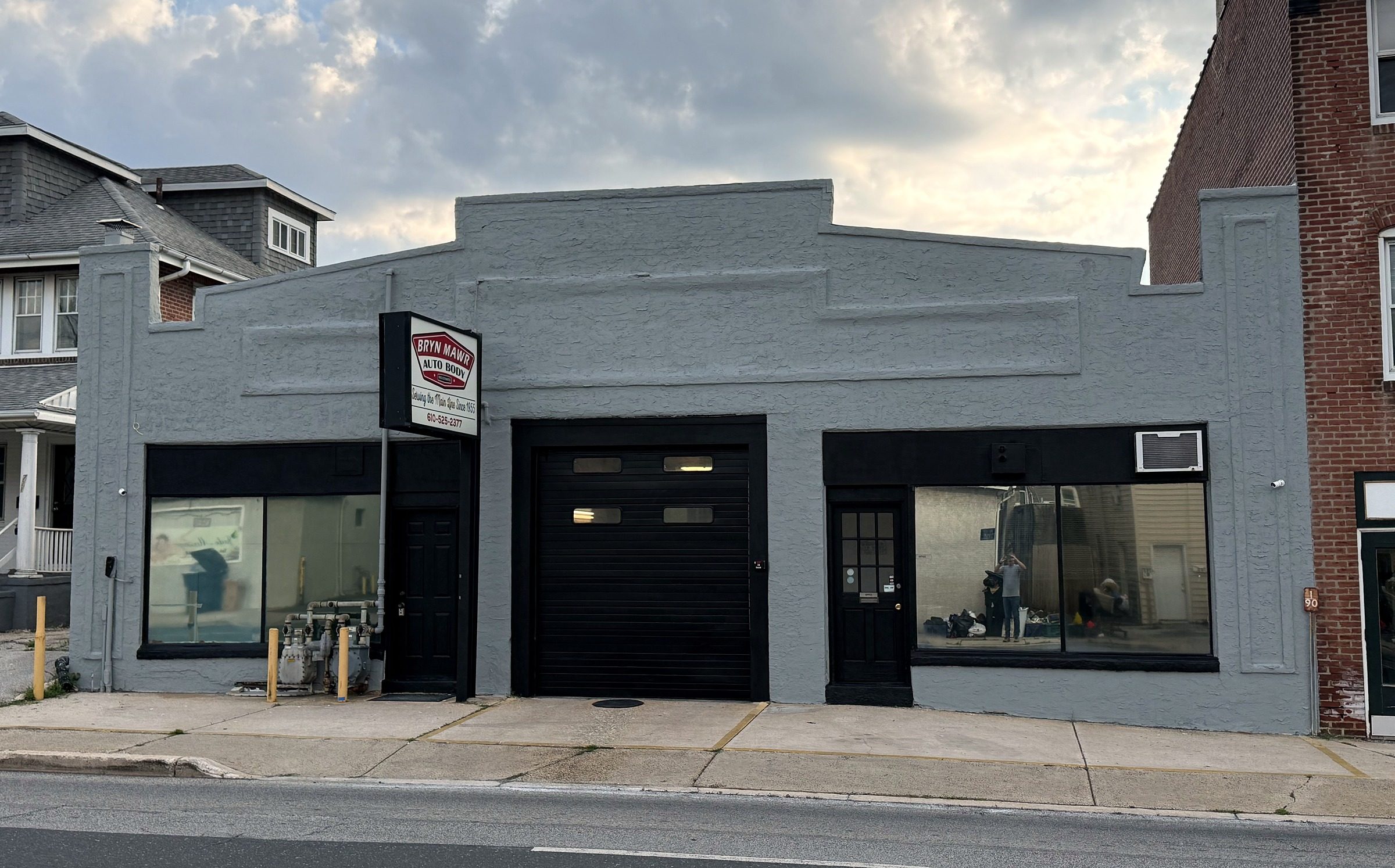 The Bryn Mawr Auto Body building on West Haverford Road: a grey storefront with the red shop sign